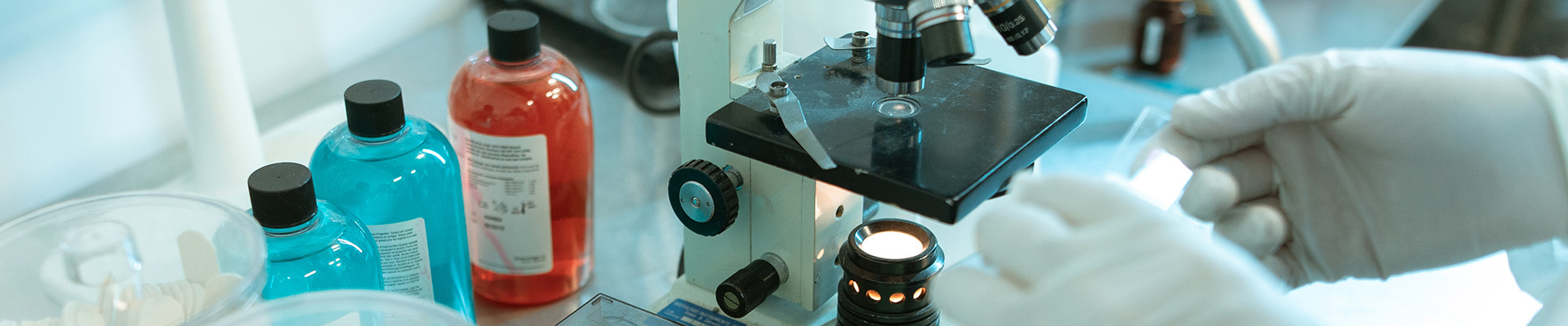 Doctor placing a slide onto a microscope